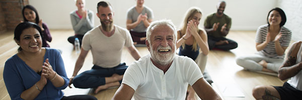 Happy group of people doing yoga.