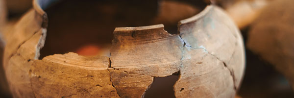 Broken clay pots with pieces forming the broken pot.