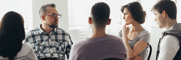 A group of people talking in a stressful way.
